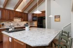 Updated Kitchen with Large Stone Countertop and Seating for 2